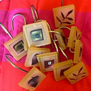 12 Shower curtain hooks. Resin . Green /maroon leaf pattern
